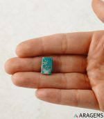 Iranian turquoise cabochon shown on hand to display real-life size and pyrite inclusions.-T6-Aragems