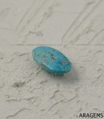 Perspective view of oval Persian turquoise cabochon showing domed shape and natural surface patterns.T8-Aragems