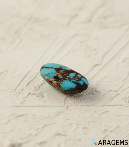 Perspective view of blue Persian turquoise cabochon showing domed shape and polished surface.Aragems