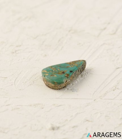 Perspective view of teardrop Neyshabur turquoise showing cabochon dome and natural surface details.t15 | Aragems
