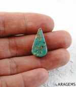 Neyshabur turquoise cabochon shown on hand to display real-life size.t15 | Aragems