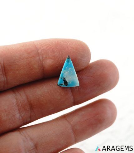 Triangular Neyshabur turquoise cabochon shown on hand to display real-life size.t16-Aragems