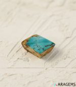 Perspective view of rectangular Persian turquoise cabochon highlighting dome polish and thickness..t17