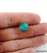 Neyshabur Persian turquoise cabochon displayed on hand to show real-life size.t17