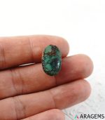 Green Neyshabur Persian turquoise cabochon shown on hand to demonstrate real-life size and depth.t19