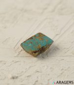 Perspective view of rectangular Iranian turquoise cabochon highlighting spiderweb matrix.