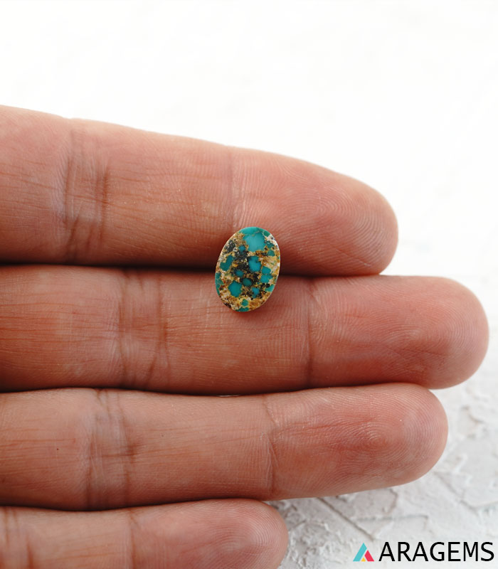 Natural Persian turquoise cabochon shown on hand to demonstrate real-life size and thin cabochon profile.t24