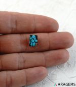 Blue Persian turquoise cabochon displayed on hand to show real-life scale.t25-Aragems