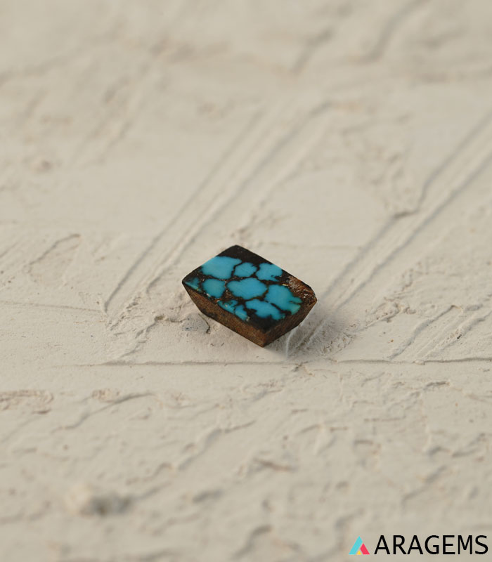 Perspective view of rectangular blue Persian turquoise highlighting matrix pattern and polish.t25-Aragems