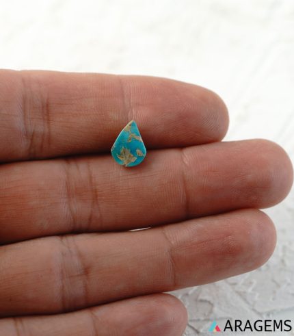 Blue Iranian turquoise cabochon shown on hand for real-life size reference.t26-Aragems