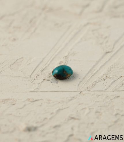 Perspective view of oval Iranian turquoise cabochon showing polished dome and natural pattern.T28-Aragems