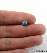 Iranian turquoise cabochon shown on hand to display real-life scale and natural color.T28 | Aragems