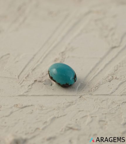 Perspective view of light blue Iranian turquoise cabochon showing polished dome.T29 | Aragems