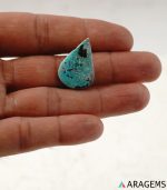Persian turquoise cabochon shown on hand to demonstrate real-life size and scale.T30