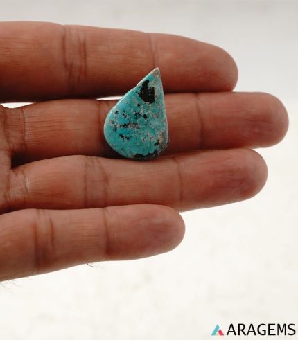 Persian turquoise cabochon shown on hand to demonstrate real-life size and scale.T30