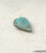 Perspective view of pear-shaped Persian turquoise cabochon highlighting dome polish and thickness.T30