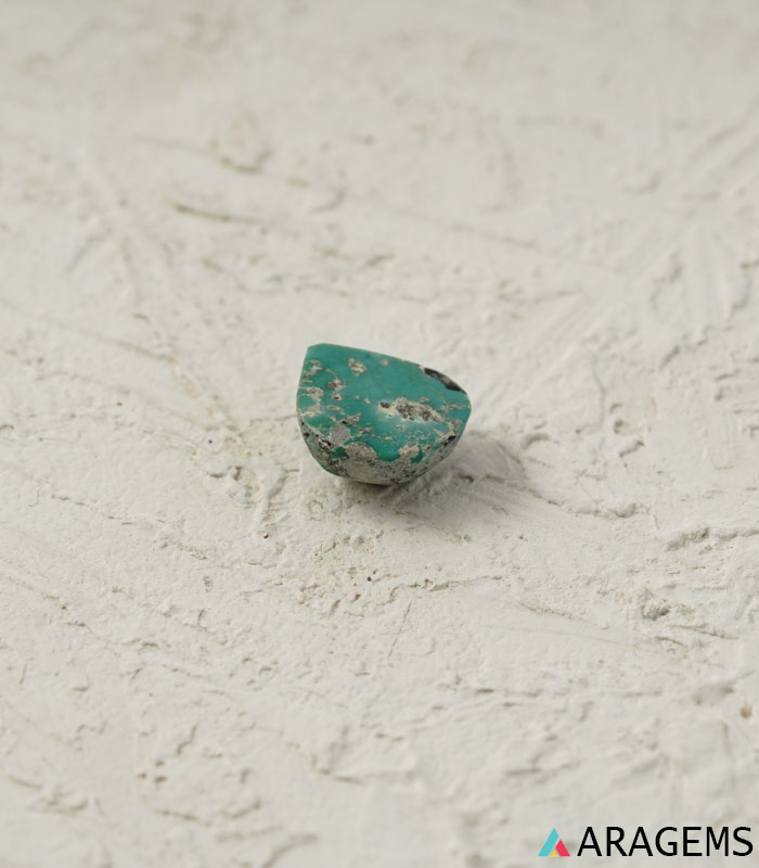 Perspective view of pear-shaped Iranian turquoise cabochon highlighting dome polish and 5 mm thickness.t31