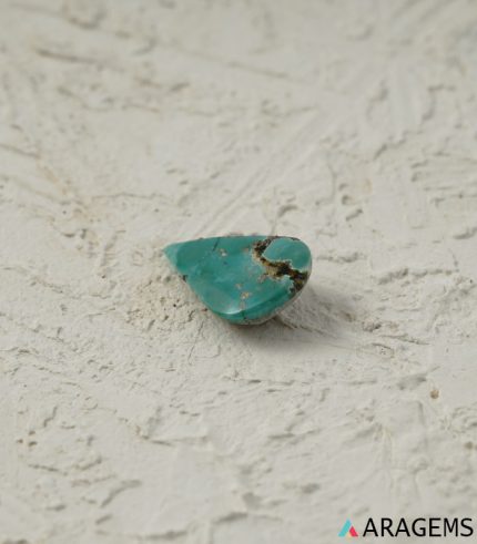 Perspective view of green-blue Persian turquoise teardrop cabochon highlighting smooth dome and natural polish.t32