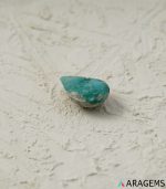 Perspective view of Iranian turquoise teardrop cabochon highlighting medium dome and smooth natural polish.T33