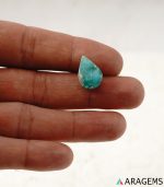 Natural Iranian turquoise from Kerman mine shown on hand to demonstrate real-life size and cabochon proportions.T33
