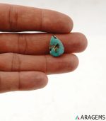 Natural Iranian turquoise from Kerman mine shown on hand to demonstrate real-life size and natural surface details.