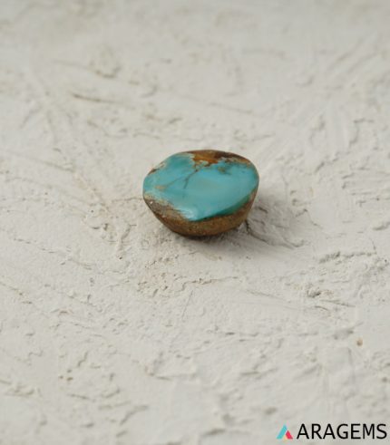 Perspective of Kerman turquoise cabochon showing natural brown host-rock texture - T36