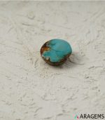 Side profile of natural green Kerman turquoise round cabochon showing dome height - T36