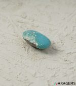 Natural blue Kerman turquoise cabochon showing white matrix cluster, close-up view - T37