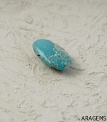 Side view of natural blue Kerman turquoise oval cabochon with white matrix edge - T37