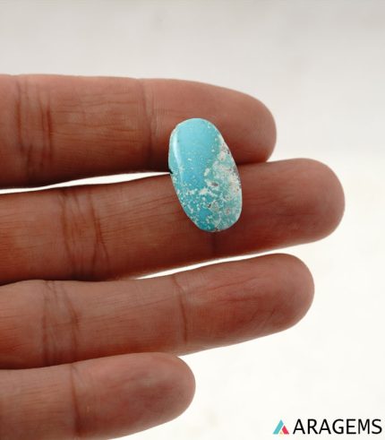 Natural Kerman turquoise cabochon shown in hand for scale, blue color with white matrix - T37