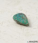 Side view of natural green Kerman turquoise teardrop cabochon with pyrite matrix - T41