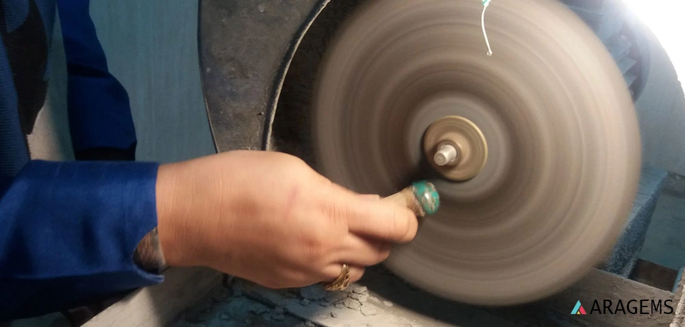 hand-carving natural Persian turquoise in the ARAGEMS lapidary workshop