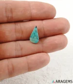 Hand holding natural teal Neyshabur turquoise teardrop cabochon showing its 8 x 16 mm size - T53