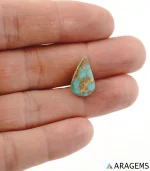 Hand holding natural blue Neyshabur turquoise teardrop cabochon showing its 9 x 17 mm size - T52
